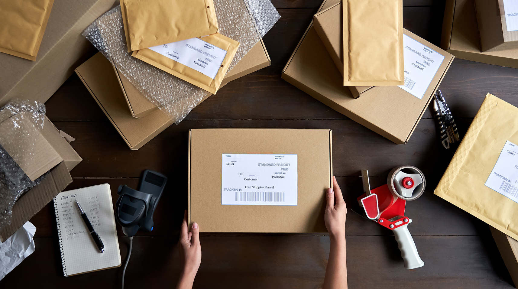 Top View of Worker Packing Shipping Order Box 